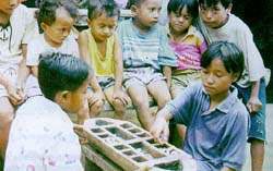 Children in Indonesian villages enjoy the traditional game of congklak
